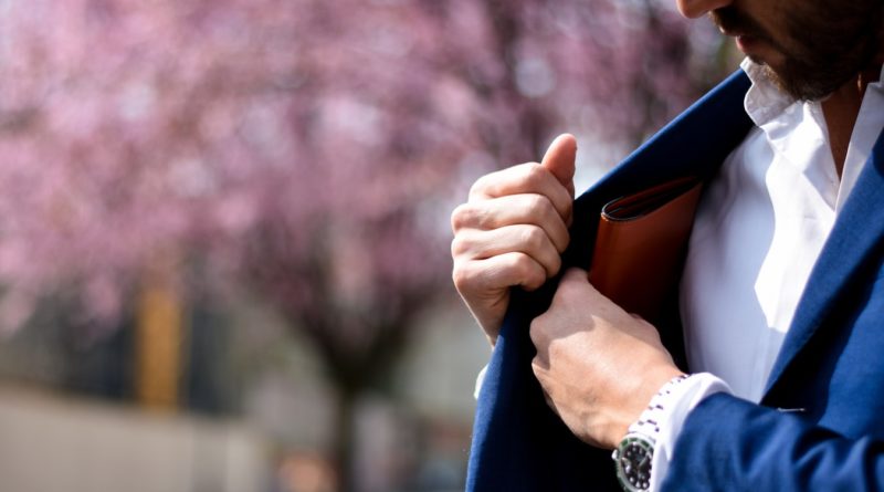 Un homme retirant un porte-monnaie de la poche de sa veste